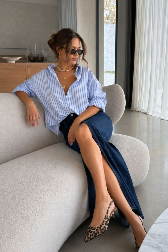 Chic outfit with blue button-down shirt and long denim skirt styled with leopard heels for an effortless expensive look