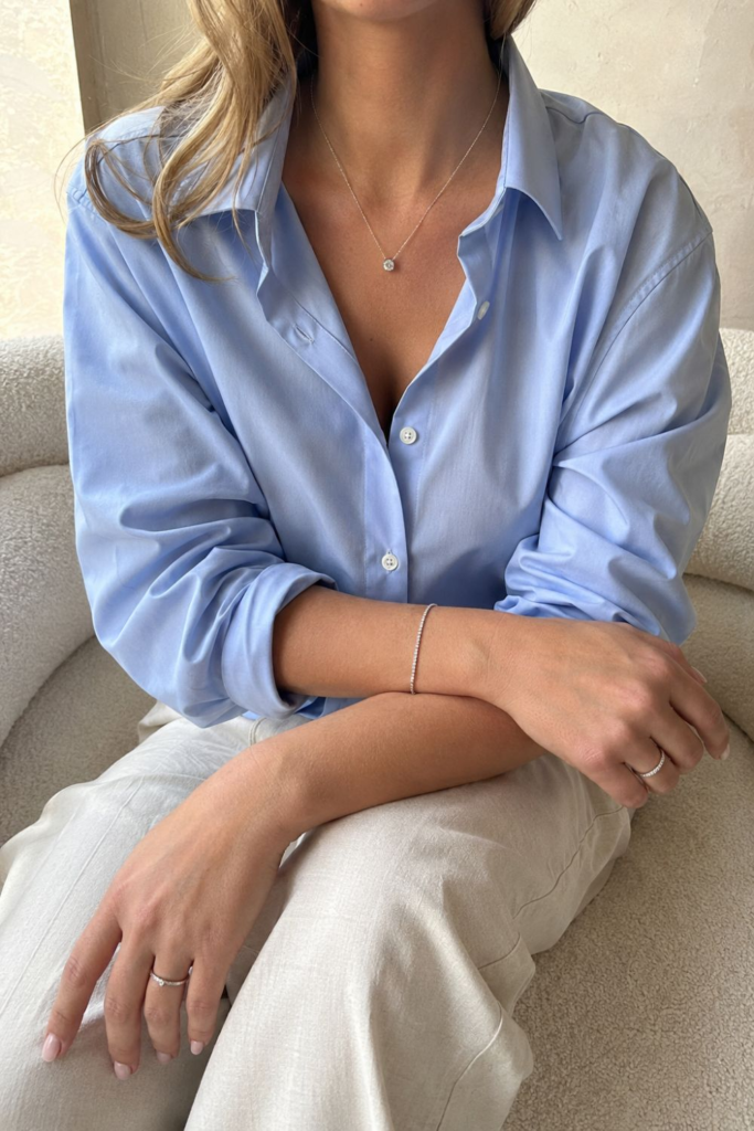 Minimalist fashion accessories for women, showcasing a diamond pendant necklace, silver bracelet, and dainty rings