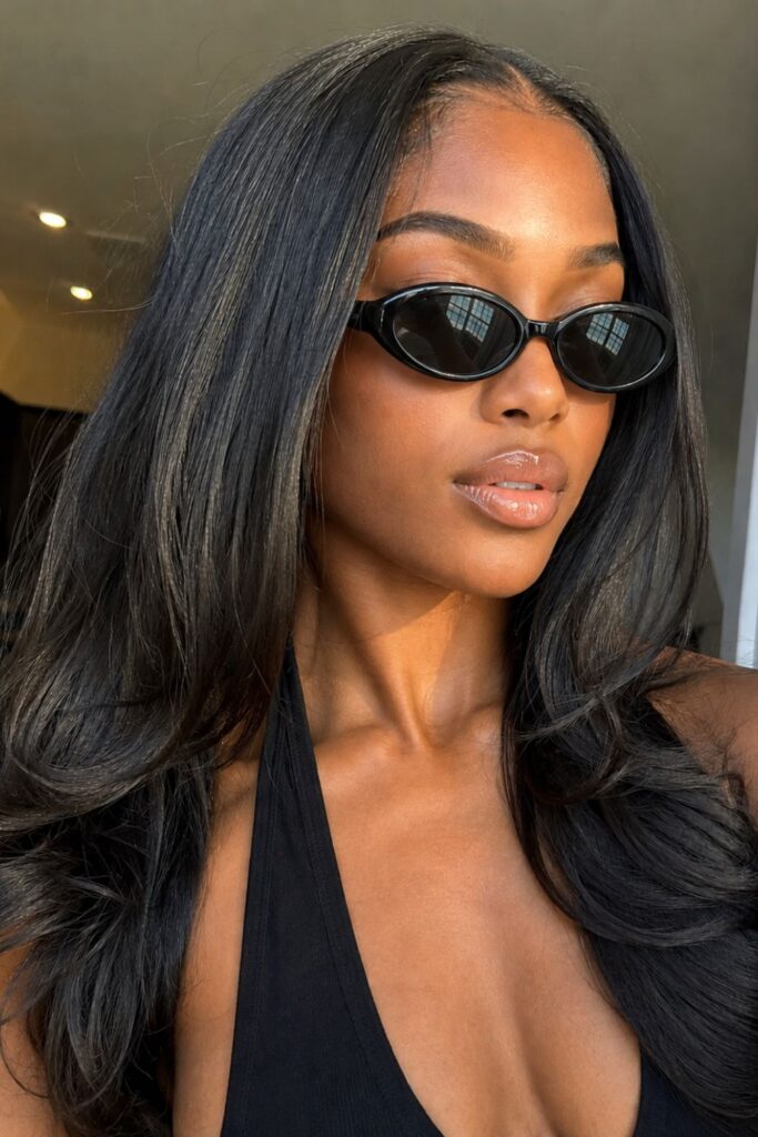 Elegant Black woman in oval sunglasses and black halter top with silky straight hair, luxury minimalist style aesthetic