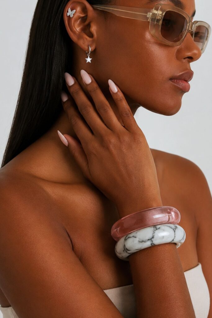 Woman wearing transparent pink sunglasses in a stylish summer fashion portrait, showcasing trendy eyewear accessories